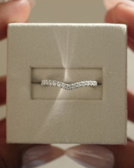 0.25 TCW round cut moissanite curved wedding band – delicate contour design crafted in polished gold, perfect for stacking with engagement rings.
