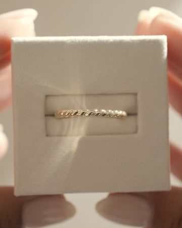 Minimalist plain twisted wedding band with a polished finish – elegant and modern gold ring design, perfect for stacking or wearing solo.